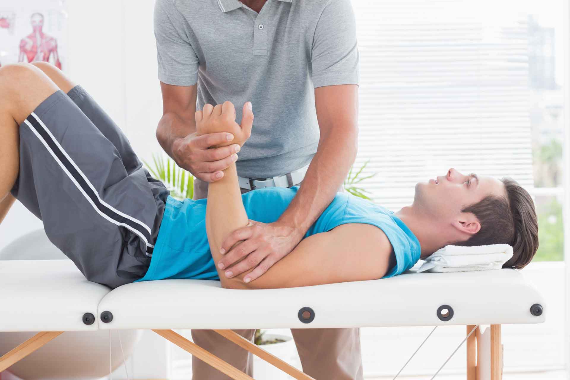 A registered massage therapist massages the right arm of a man richmond rmt massage